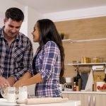 Couple cooking together in the kitchen at home