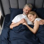 Lovely,Mature,Couple,Sleeping,Together,In,Bed,At,Home,,Above