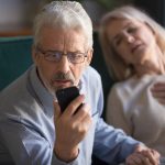 Unhappy,Mature,Man,,Husband,Calling,Emergency,,Holding,Wife,Hand,,Looking